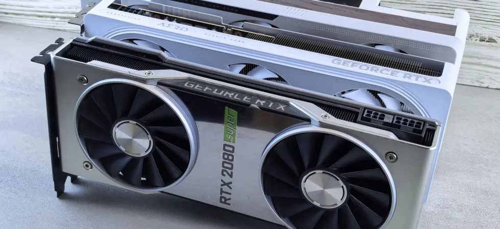Three NVIDIA GeForce RTX graphics cards stacked on a surface, showcasing their sleek design and branding details.