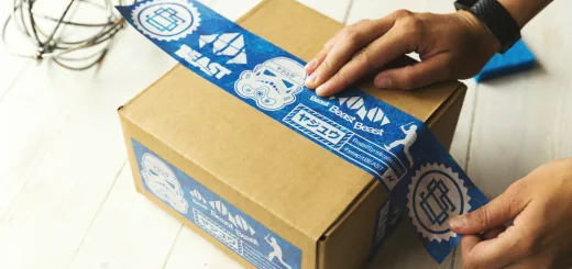 person holding brown and blue box