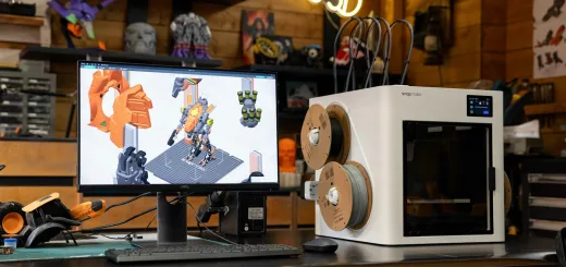 3D printer with computer displaying design on desk.