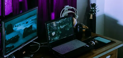 black laptop computer on brown wooden table