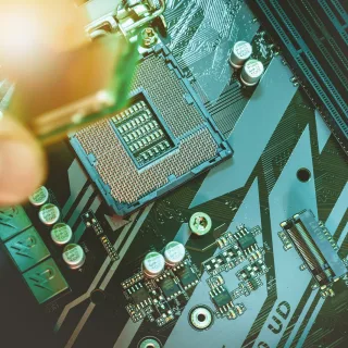 Hand installing a computer processor onto a motherboard.