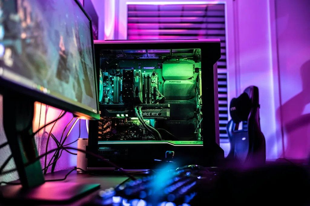 a computer monitor sitting on top of a desk next to a keyboard