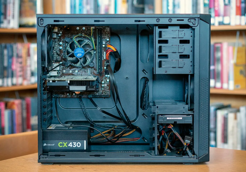 black computer tower on brown wooden table