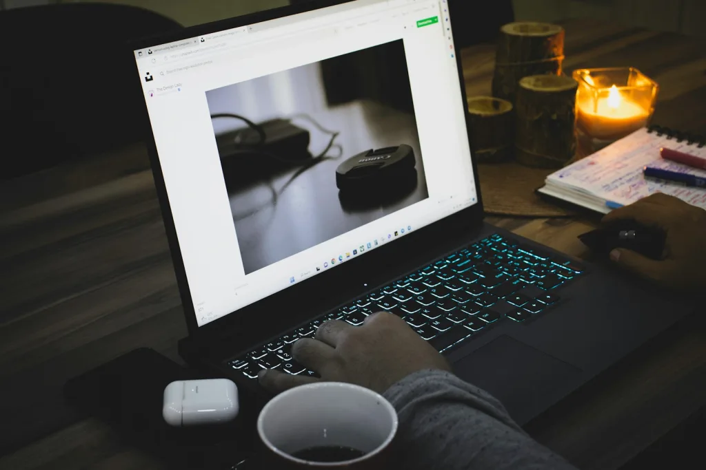 a person sitting in front of a laptop computer